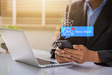 Businessman using smartphone with new email alert. Communication connection messages in global workplaces through email marketing or digital newsletter