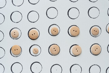 ink stamp circles and wooden buttons on paper