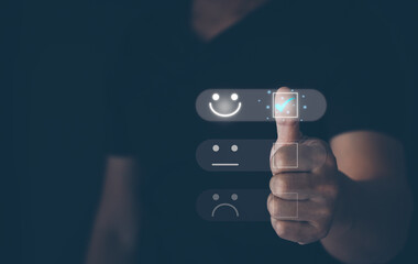 Customer service satisfaction survey concept. Business people or customers do online assessments of satisfaction by pressing virtual screen on happy smile face icon to give satisfaction in service.