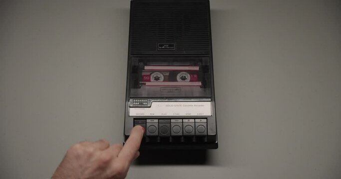 Cassette Tape Inserted Into Recorder With Record Button Pressed