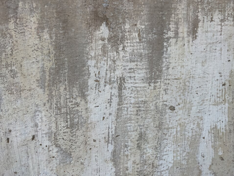 The gray cement background, painted with white paint that has faded away, reveals the texture of the cement slabs, forming a beautiful artistic background.  abstract background.