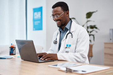 Black man, doctor and laptop with smile in healthcare for research, medicine or PHD at clinic desk. Happy African American male medical professional smiling, working or typing on computer at hospital - Powered by Adobe