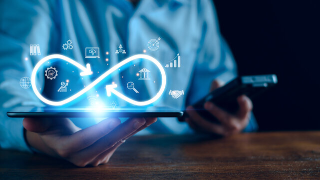 Technology infinity data link concept, Businessman Hands holding virtual infinity with technology marketing online icon for symbol of connection to community metaverse world network system concept.