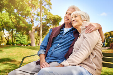 Park, thinking and love with a senior couple sitting on a bench together on a summer day for romance. Nature, garden or memory with a mature man and woman bonding outdoor during retirement