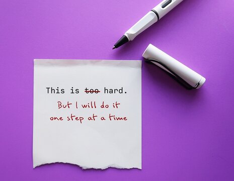 On purple copy space background with pen add on torn note message THIS IS TOO HARD with BUT I WILL DO IT ONE STEP AT A TIME, to overcome negative self talk and challenge hard big job management