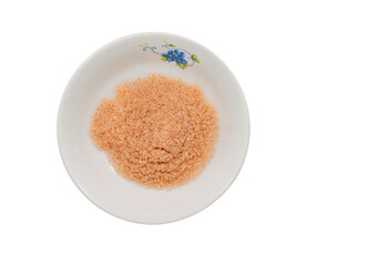 Top view pink salt or Himalayan salt in small dish, isolated image on white background.