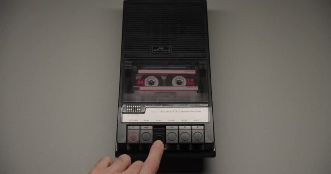 Cassette Tape Inserted Into Recorder With Play Button Pressed