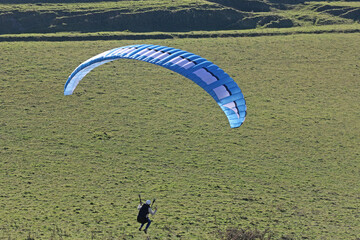 Paraglider flying from a hill