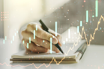 Abstract creative financial graph with hand writing in diary on background, financial and trading concept. Multiexposure