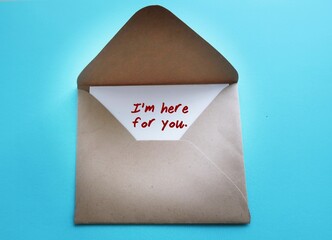 Envelope with text written card I'M HERE FOR YOU - concept of a cheer up note to someone to...