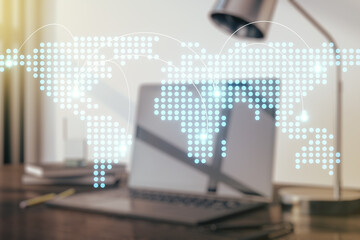 Abstract creative world map with connections on modern laptop background, international trading concept. Multiexposure