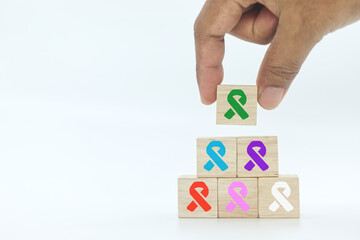 hand picking up wooden block cube with green color ribbon icon on white background.Liver, Gallbladders bile duct, kidney Cancer and Lymphoma Awareness month concept .   