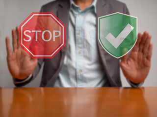 A businessman put hands to show symbol of stop and safety or approved. A green icon can be interpreted for safety sign, approved and checked. Conception of stop checked safety first then clear and go. - 575529073