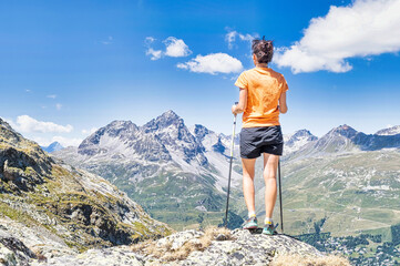 A young woman observes the view in the mountains