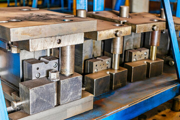Forms for a hydraulic press on a rack. industrial metalworking machines. Close-up of hydraulic...