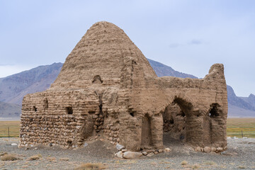 Fototapeta na wymiar Closeup view of the ruins of ancient silk road Chinese tomb or caravanserai along Pamir highway, Bash Gumbaz near Alichur, Gorno-Badakshan, Tajikistan