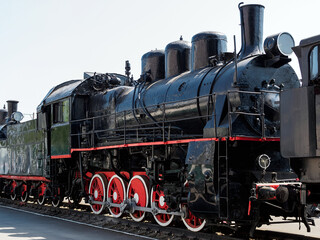 Fototapeta na wymiar vintage black steam locomotive outdoors