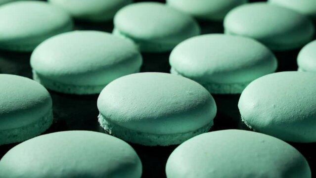 Macaroons. Baking turquoise macaroons in electric oven. Timelapse of growing macarons. Delicious dessert. Process of cooking macaroons