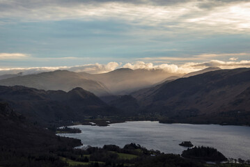 Fototapeta na wymiar Absolutely wonderful landscape image of view across Derwentwater from Latrigg Fell in lake District during Winter beautiful colorful sunset