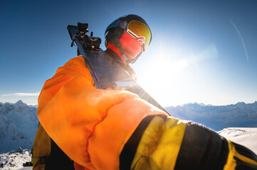 Portrait of a skier against the backdrop of the snow-capped mountains of the Caucasus. a man in a...