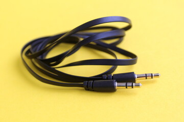 The connector for gadgets lies on a yellow background.