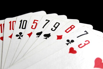 Obraz premium Playing cards lie on a black isolated background.