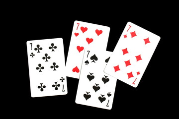 Playing cards lie on a black isolated background.