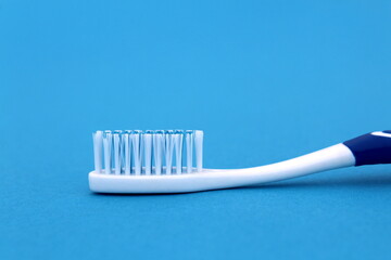 On a blue background lies a new toothbrush.