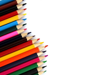 Bright colored pencils lie on a white background with space for text.