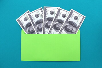 Dollar bills are in a green envelope.