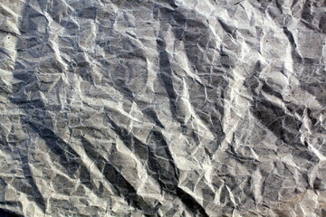 Abstract texture from gray crumpled paper, top view.