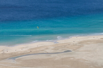 Aerial photo of a kitesurfer in Fuerteventura's famous Sotavento beach. In Sotavento beach every year the kitesurf and windsurf world championship is held.