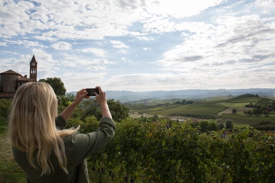 Woman takes pic across hills and vineyards