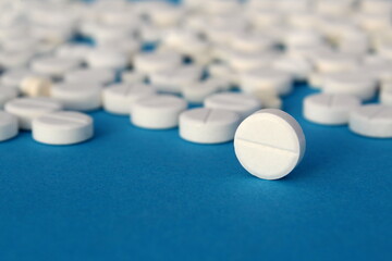 White pills lie on a gray background.