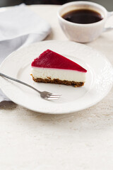 Delicious slice of red cranberry Cheesecake on a plate. Homemade baking