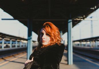 red-haired woman in train station
