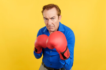 Mature man with boxing gloves in guard pose of boxing