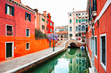 Fototapeta na wymiar Old colorful architecture on the canal with bridge in Venice, Italy.
