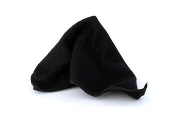A black rag for cleaning lies on a white isolated background.