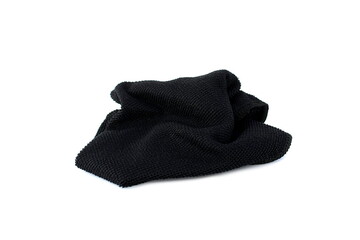  A black rag for cleaning lies on a white isolated background.