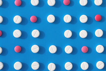 Abstract background of white pills on a blue background.