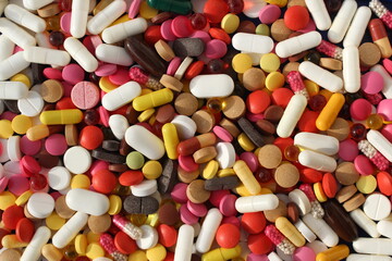A lot of different medication pills are in one heap. - Powered by Adobe