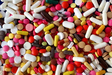 A lot of different medication pills are in one heap.