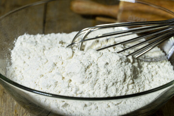 Preparing white all-purpose flour in the glass bowl