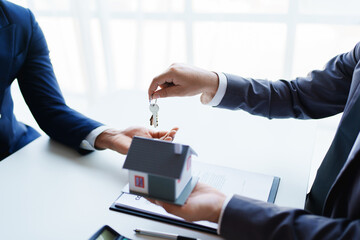 Real estate company to buy houses and land are delivering keys and houses to customers after...