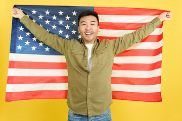 Happy chinese man raising a USA national flag