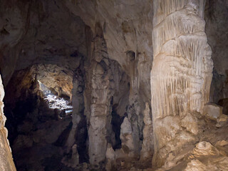 stalactites, stalagmites and large calcareous pillars inside the cave formed over millions of years