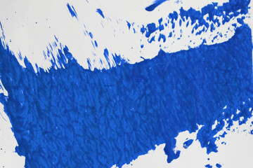 Abstract background of blue paint stains on white paper.