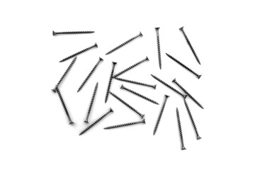 A lot of self-tapping screws lie on a white isolated background.