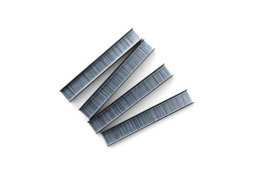 Iron staples for a construction pistol lie on a white background.	